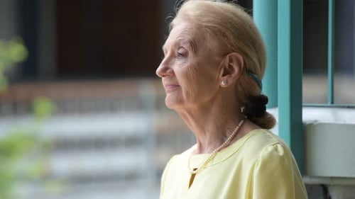 Senior Woman Smiling Profile Outside Building