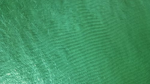 Aerial top down view from high altitude of green sea water texture
