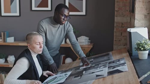 Architects Reviewing Plans in Modern Office