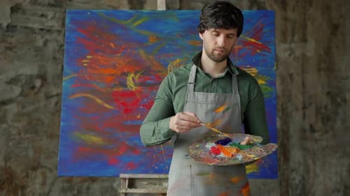 Male Artist with Palette and Painting Smiling