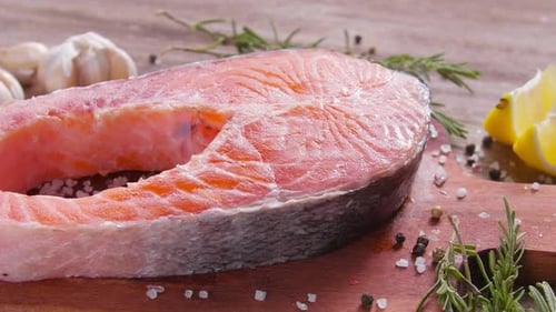 Appetizing Raw Salmon Steak with Fresh Herbs