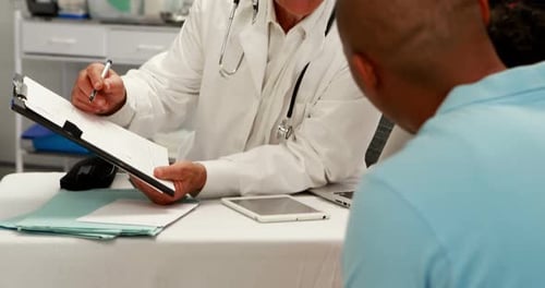 Doctor Consults Patient in Clinical Office Setting