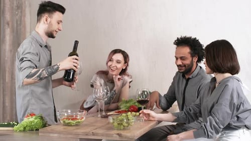 Friends Gathering Around a Table with Food and Wine