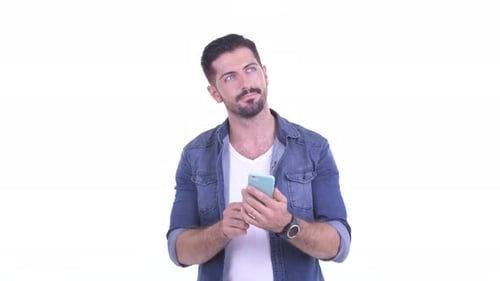 Man Using Cellphone and Looking Upward