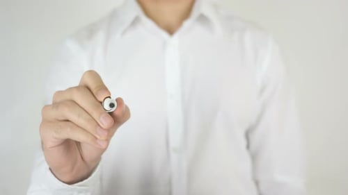 Man Writes Compliance on a Clear Surface