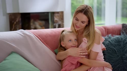 Affectionate Mother and Child Embracing on Couch