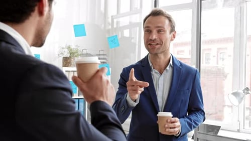 Businessmen Discussing Sales Strategy in Modern Office
