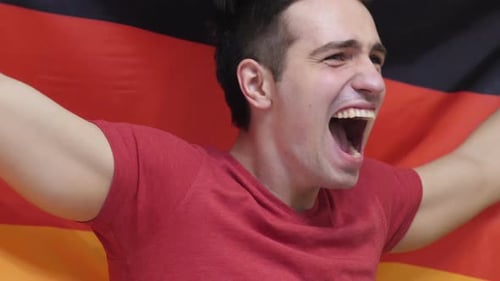 Enthusiastic Man Cheering and Waving a Flag