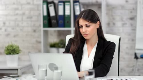Focused Successful Young Beautiful Businesswoman Working on Laptop at Modern Office Medium Shot