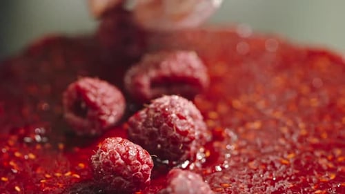 Placing Fresh Raspberries on Berry Tart Close Up