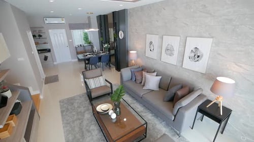 Sala de estar totalmente decorada con muebles e iluminación elegantes