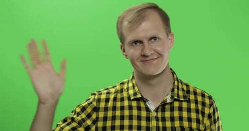 Handsome Caucasian Man Waves and Saluting on Green Screen Chroma Key