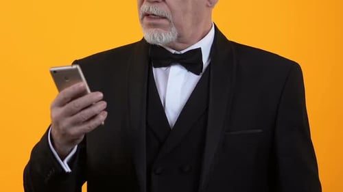 Excited Senior Man with Smartphone Holding Money