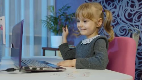 Child Girl Calling To Teacher on Laptop Distance Education Learning at Home on Coronavirus Lockdown