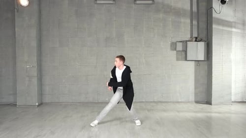 Modern Style Dancer Working Out on Studio Background
