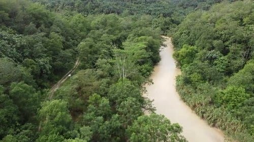Aerial move over rural path and river