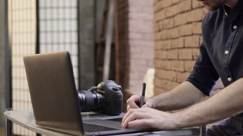 Photographer Works on Laptop and Drawing Tablet