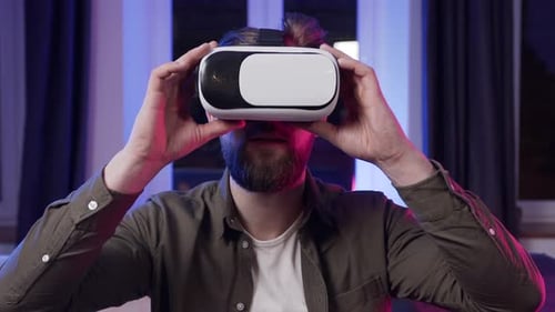 Man Puts On VR Headset in Interior Room