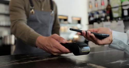 Close Up in the Cafe Man Makes Takeaway Coffee for a Customer Who Pays By Contactless Mobile Phone