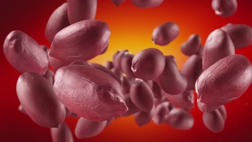 Peanuts Falling Against Red and Orange Background