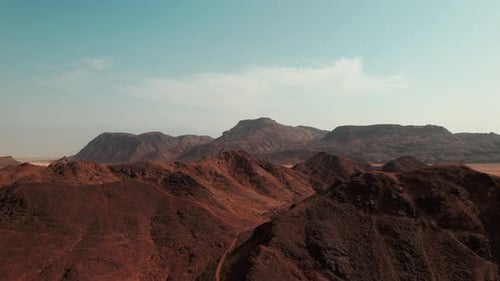 Aerial reveal of a huge colorful desert mountain line and horizon.
Filmed in southern Israel, near E