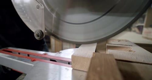 Slow Motion Close Up the Master Cuts a Wooden Board with a Circular Saw in the Woodworking Workshop