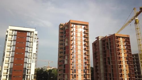 Aerial view of tall residential apartment buildings under construction. Real estate development.