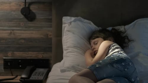 Girl Sleeping Peacefully in Bed at Night
