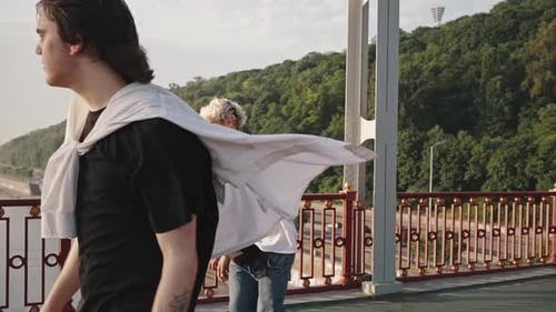 Young Skaters on an Empty Footbridge Do Tricks and Ride Boards