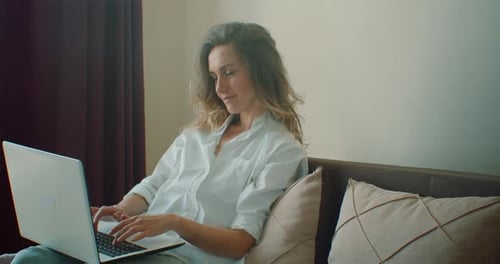 Woman Uses Laptop in Bright Home Setting