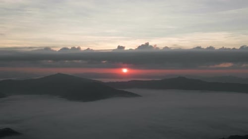 Scenic Sunrise Over Fog-Covered Mountains