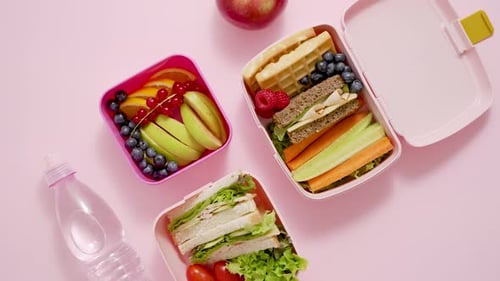 Colorful Lunchboxes with Healthy Snack Items Overhead