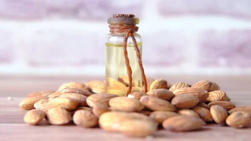Almond Oil in Bottle on Wooden Background