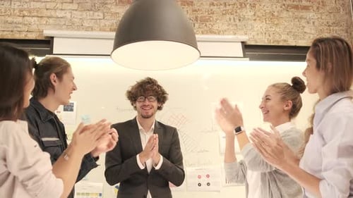 Excited Business Team Tossing Documents in the Air