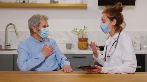 Portrait Multiethnic Female Doctor in White Medical Coat and Satisfied Senior Patient Talk About