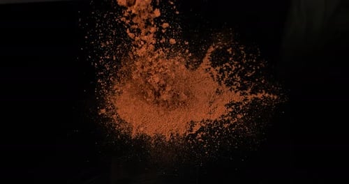 Paprika, capsicum annuum, Powder Falling against Black Background, Slow Motion 4K