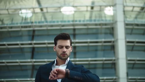 Handsome Businessman Checking Watch Near Office Building
