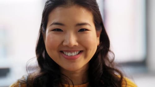 Close Up of Young Woman Smiling at Camera