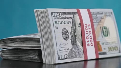 Stacks of one hundred dollar bills on table