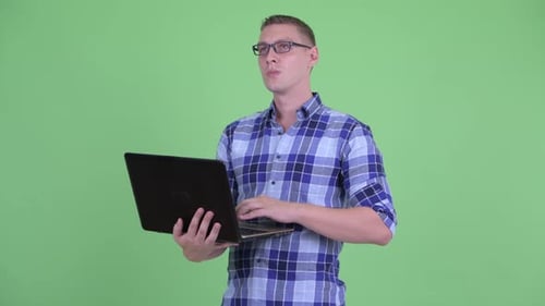 Man with Laptop Smiling in Studio