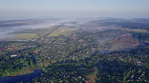 Sunrise with Fog Above Village in Morning