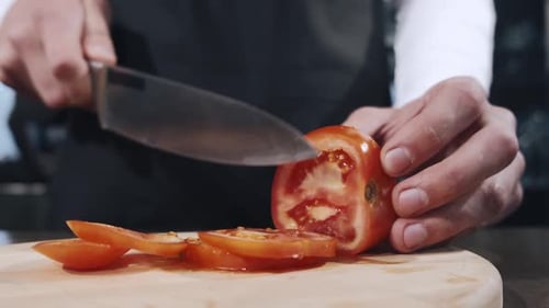 Slicing a Fresh Tomato with a Sharp Knife