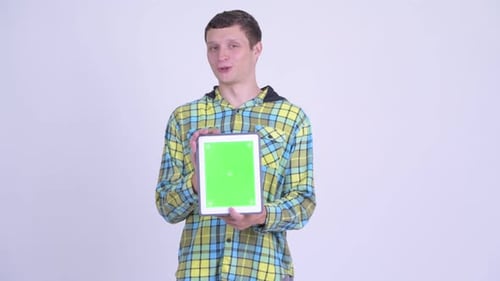 Young Adult Holds Up Tablet with Green Screen