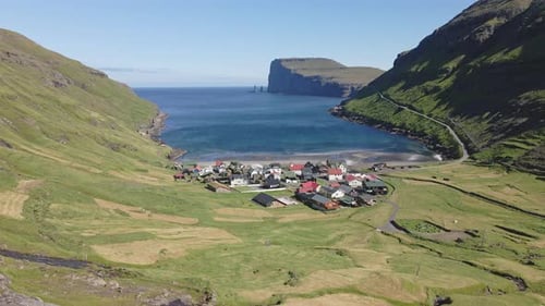Wavy Ocean Waters Nearby Village and Lush Mountain Fields in Tjornuvik