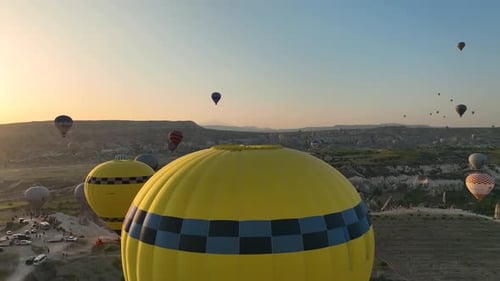 4K Aerial view of Goreme. Colorful hot air balloons fly over the valleys.