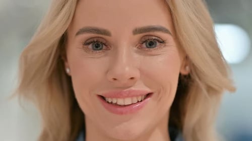Close Up of Face of Young Woman Smiling at Camera