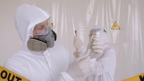 A Two Doctors in a Medical Suit Testing a New Vaccine Against Coronavirus.