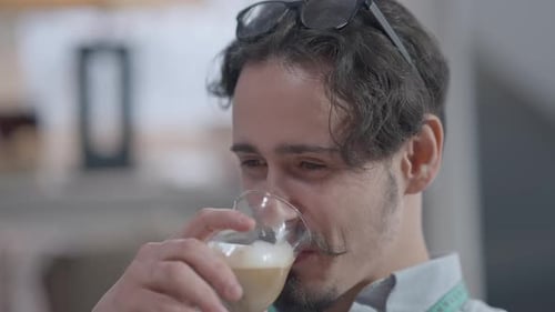 Man Drinks From Glass Indoors Close Up