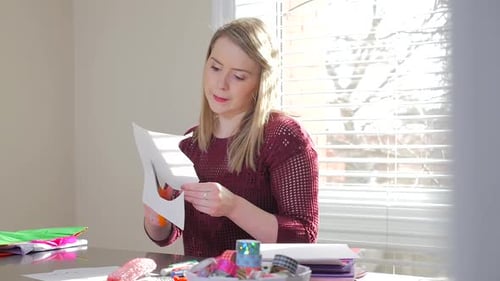 Woman Cutting Paper with Scissors for Arts and Crafts