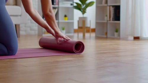 Close up Hands preparing Yoga mat on the floor ready for practice